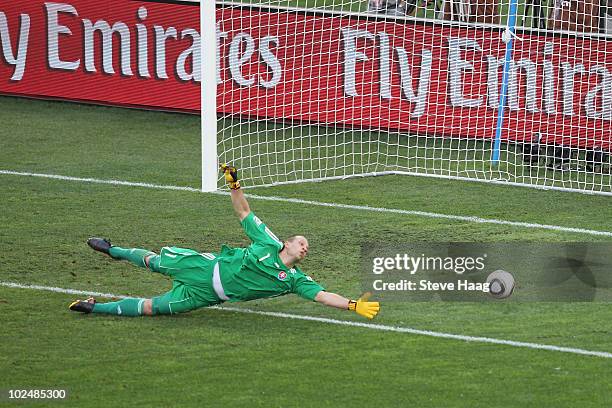 Jan Mucha of Slovakia dives in vain as Arjen Robben of the Netherlands scores the first goal during the 2010 FIFA World Cup South Africa Round of...