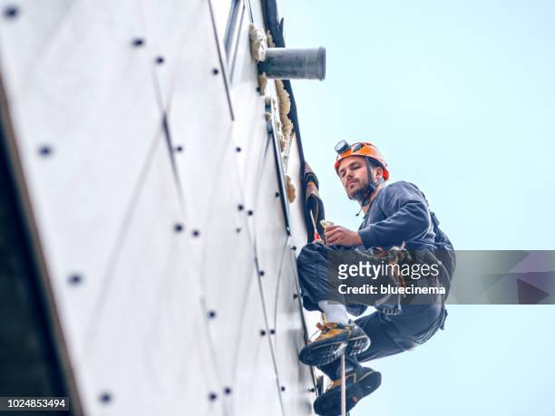 abseiling building maintenance workers at work - rappelling stock pictures, royalty-free photos & images