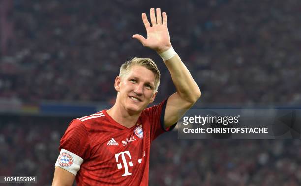 Former Bayern Munich's midfielder Bastian Schweinsteiger waves during he come for the second time of his farewell match for Bastian Schweinsteiger...