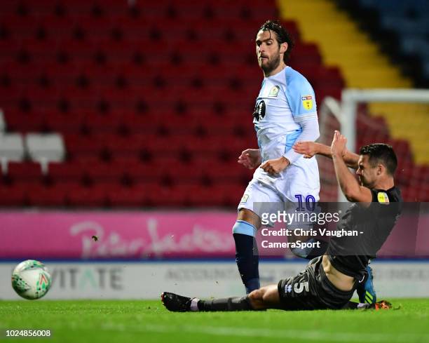 Blackburn Rovers' Danny Graham, under pressure from Lincoln City's Jason Shackell, scores his side's second goal during the Carabao Cup Second Round...