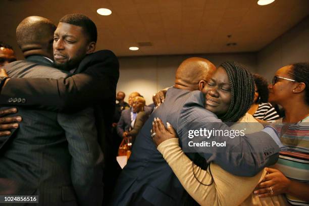 Parents of Jordan Edwards, Odell and Charmaine Edwards , hug prosecutor George Lewis and family member Reggie Edwards , as they react to a guilty of...