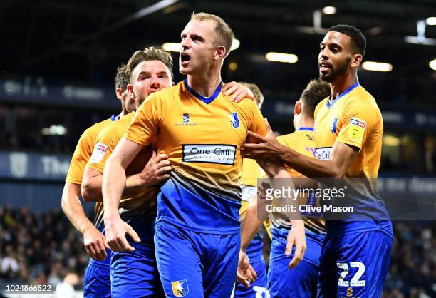 Neal Bishop of Mansfield Town celebrates with teammates after scoring his team's first goal during the Carabao Cup Second Round match between West...