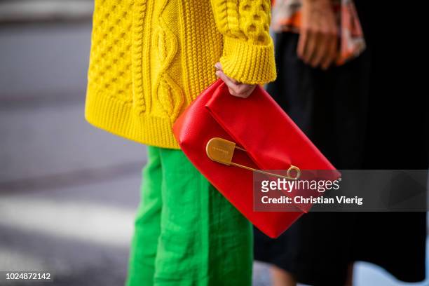 Emili Sindlev wearing yellow knit cardigan, green wide leg pants, Burberry clutch seen during Stockholm Runway SS19 on August 28, 2018 in Stockholm,...