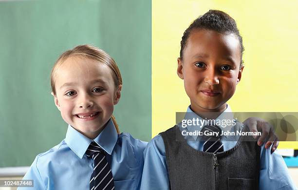 two school friends embracing - newfamily stock pictures, royalty-free photos & images