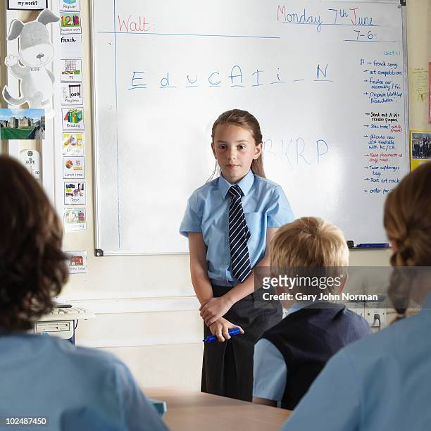 young student at front of class - newfamily stock pictures, royalty-free photos & images