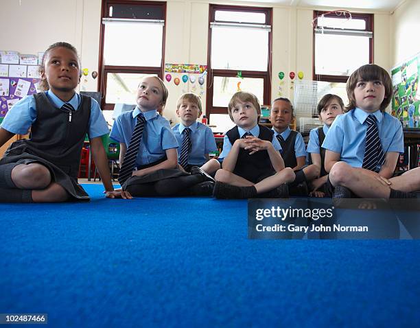 young school children listen to teacher - primary school children in uniform stock pictures, royalty-free photos & images