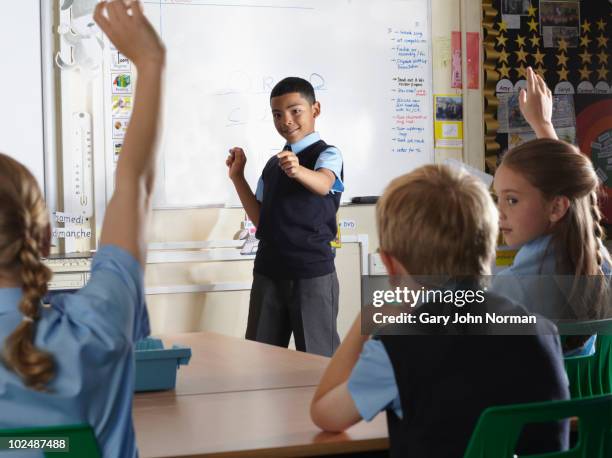 young student at front of class - newfamily stock pictures, royalty-free photos & images