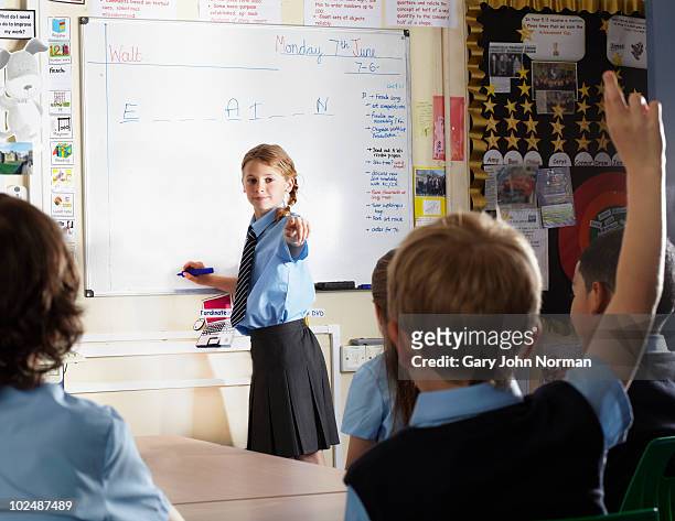 young student at front of class - newfamily stock pictures, royalty-free photos & images