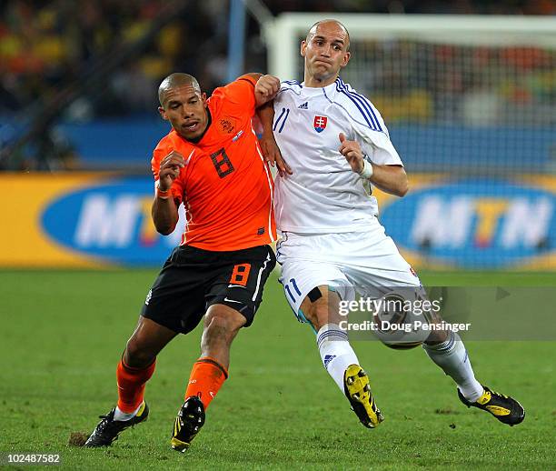 Robert Vittek of Slovakia and Nigel De Jong of the Netherlands challenge for the ball during the 2010 FIFA World Cup South Africa Round of Sixteen...