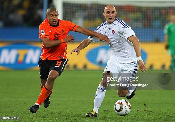 Robert Vittek of Slovakia and Nigel De Jong of the Netherlands challenge for the ball during the 2010 FIFA World Cup South Africa Round of Sixteen...