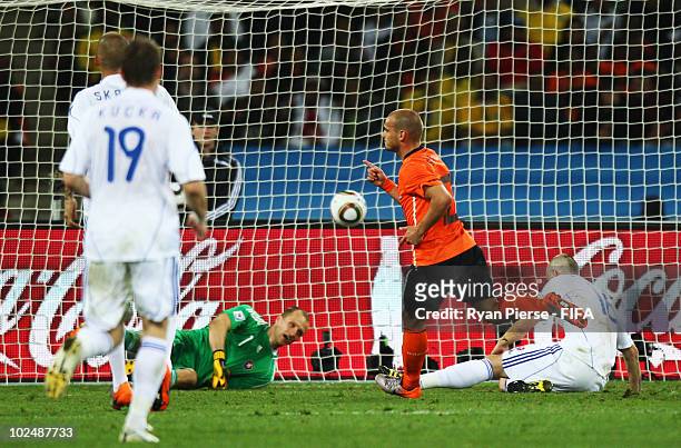 Wesley Sneijder of the Netherlands scores his side's second goal past Jan Mucha of Slovakia during the 2010 FIFA World Cup South Africa Round of...