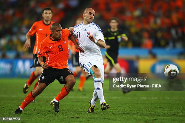 Nigel De Jong of the Netherlands Robert and Robert Vittek of Slovakia battle for the ball during the 2010 FIFA World Cup South Africa Round of...