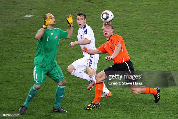 Dirk Kuyt of the Netherlands attacks as Jan Mucha of Slovakia defends during the 2010 FIFA World Cup South Africa Round of Sixteen match between...