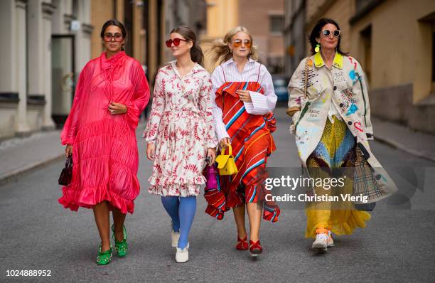 Group of guests wearing mulit color dresses seen during Stockholm Runway SS19 on August 28, 2018 in Stockholm, Sweden.