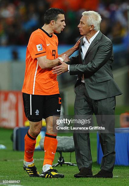 Robin Van Persie talks to Bert van Marwijk head coach of the Netherlands as he is substitued for Klaas Jan Huntelaar during the 2010 FIFA World Cup...