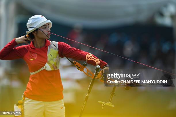 China's Zhang Xinyan competes in the archery recurve women's individual final round against Indonesia's Diananda Choirunisa at the 2018 Asian Games...
