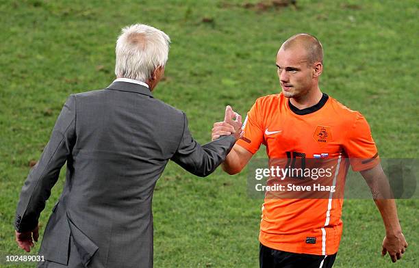 Wesley Sneijder of the Netherlands celebrates victory with Bert van Marwijk head coach of the Netherlands following the 2010 FIFA World Cup South...