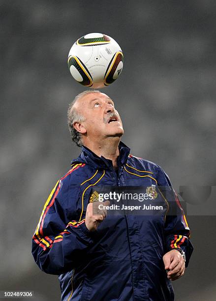 Head coach Vicente del Bosque of Spain heads a ball during a training session, ahead of their 2010 World Cup Stage 2 Round of 16 match against...