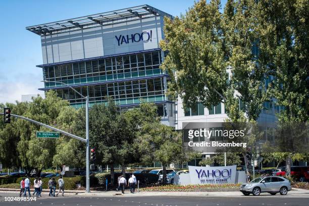 People walk in front of the Oath Inc. Yahoo! headquarters in Sunnyvale, California, U.S., on Tuesday, Aug. 28, 2018. Yahoo pitched a service to...
