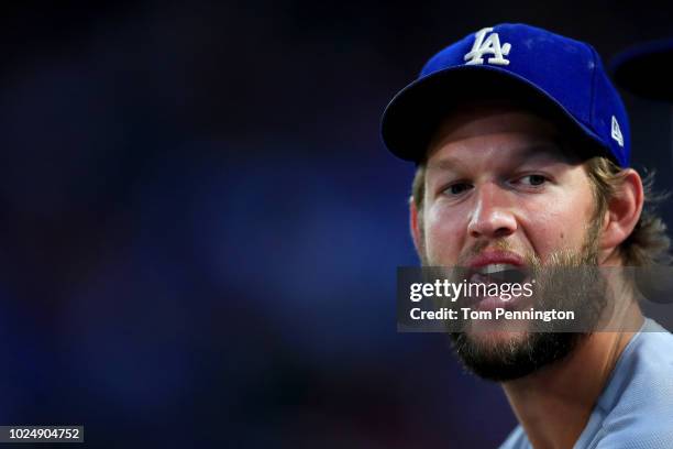 Clayton Kershaw of the Los Angeles Dodgers looks on from the dugout as the Los Angeles Dodgers take on the Texas Rangers in the bottom of the second...