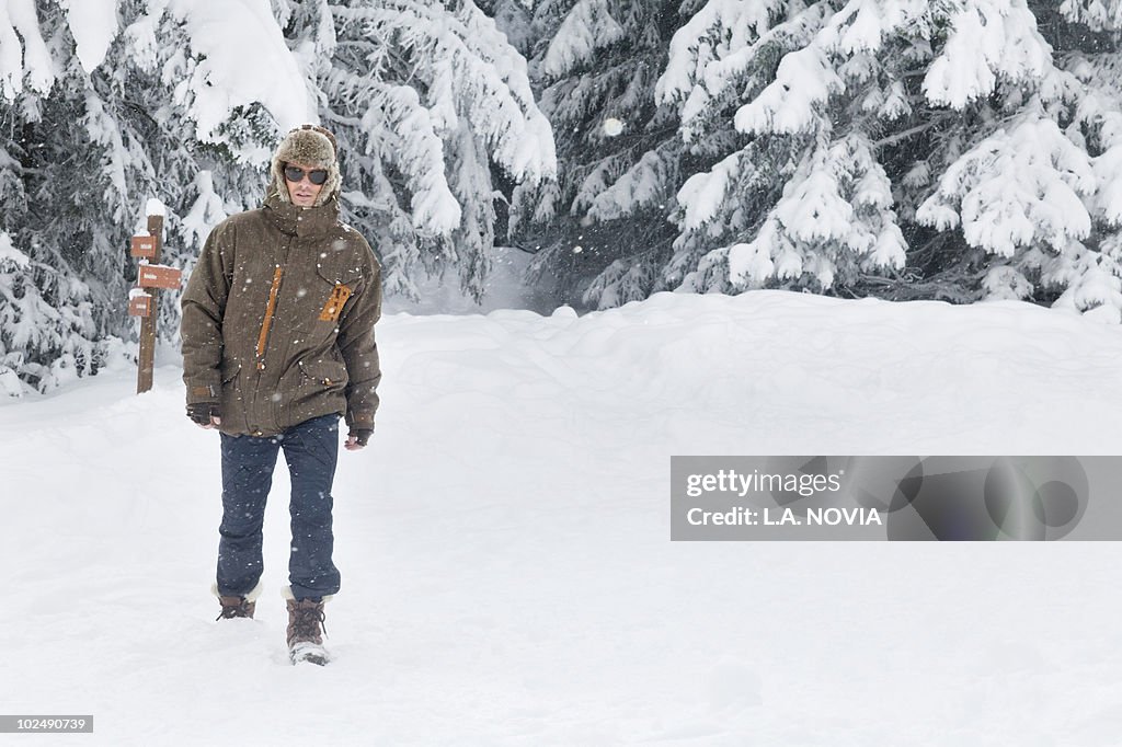 Young man walking in snow