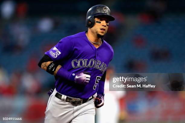 Carlos Gonzalez of the Colorado Rockies rounds second base after hitting a solo homerun during the first inning of a game against the Los Angeles...