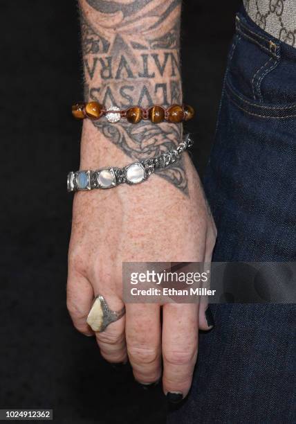 Singer Adam Lambert, jewelry detail, of Queen + Adam Lambert poses after a news conference at the MGM Resorts aviation hangar to kick off the group's...