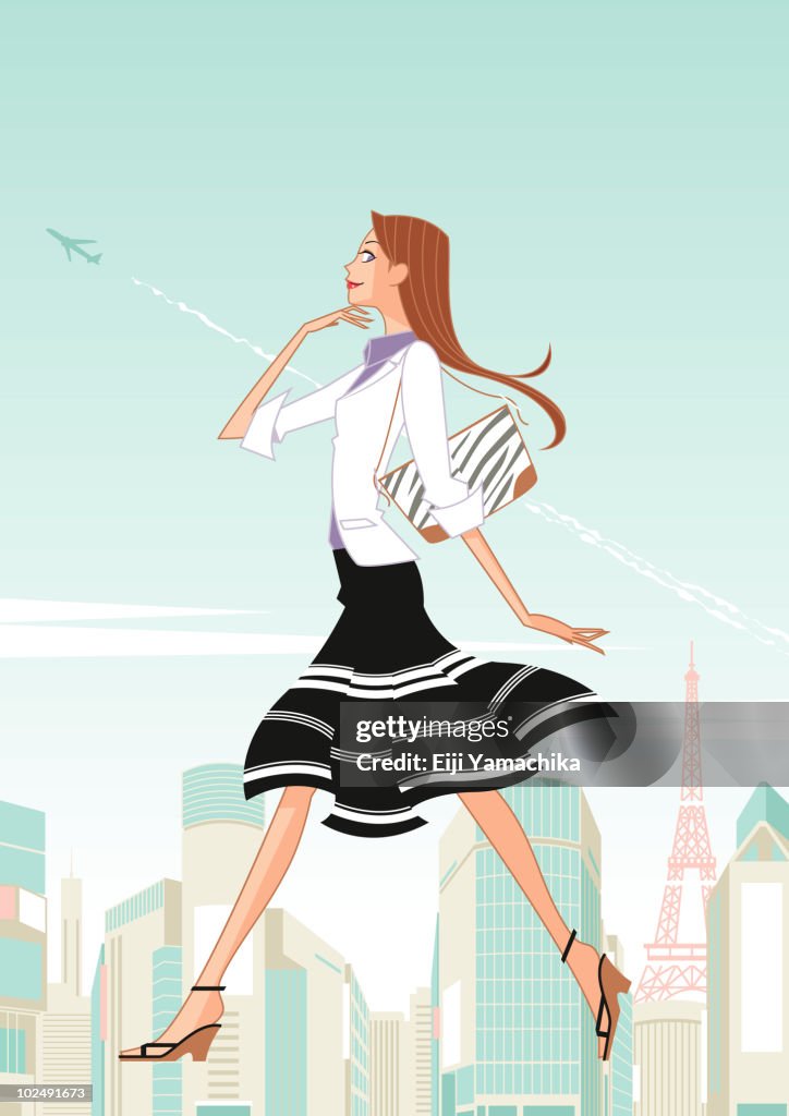 Woman walking across parisan skyline