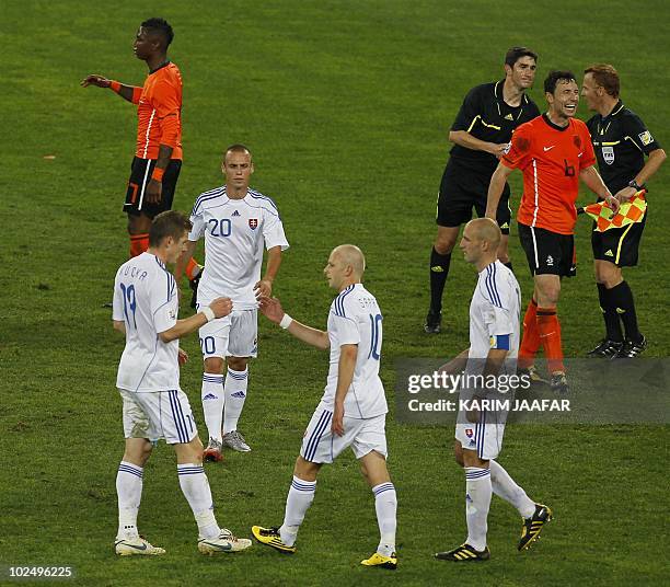 Slovakia's midfielder Kamil Kopunek , Slovakia's midfielder Marek Sapara and Slovakia's striker Robert Vittek deject as Netherlands' striker Robin...