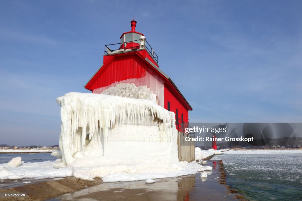 Ice covered Lighthouse on Lake Michigan in winter