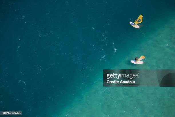 An aerial view people windsurfing at the Turkish wind tourism capital Alacati in Izmir, Turkey on August 18, 2018. Turkey has a coastline of 8,333...