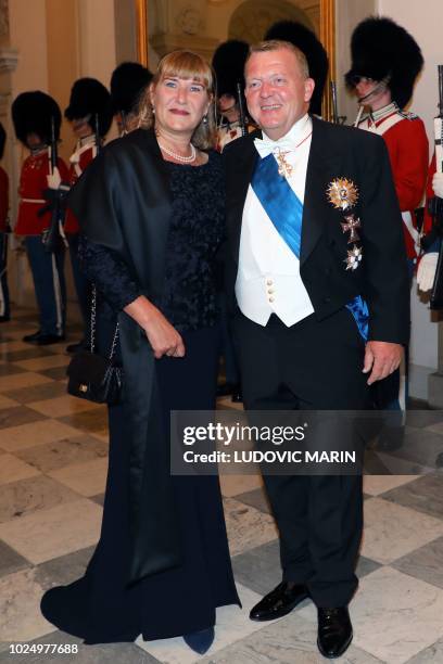 Denmark's Prime Minister Lars Lokke Rasmussen and his wife Solrun arrive for the state dinner at Christiansborg Palace in Copenhagen on August 28,...