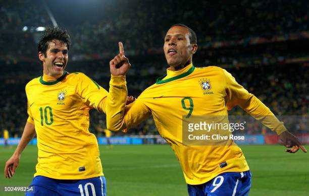 Luis Fabiano of Brazil celebrates scoring his team's second goal with team mate Kaka during the 2010 FIFA World Cup South Africa Round of Sixteen...