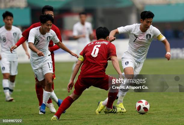 Son Heung Min of South Korea competes for the ball during the Men's Footbal semi final competition between Vietnam and South Korea held at the Pakan...