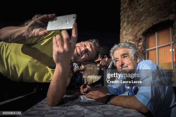 Uruguayan politician Jose 'Pepe' Mujica and Former President of Uruguay takes a selfie with a fan during the presentation of the new Italian Edition...