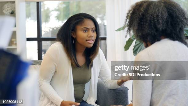 upset teenager talks with her mom - arguing blacks stock pictures, royalty-free photos & images