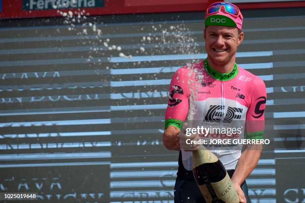 Education First-Drapac's Australian cyclist Simon Clarke celebrates on the podium after winning the fifth stage of the 73rd edition of "La Vuelta"...