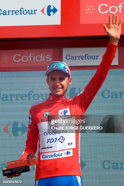 Groupama-FDJ's French cyclist Rudy Molard celebrates on the podium after retaining the Red Jersey of the general classification after the fifth stage...