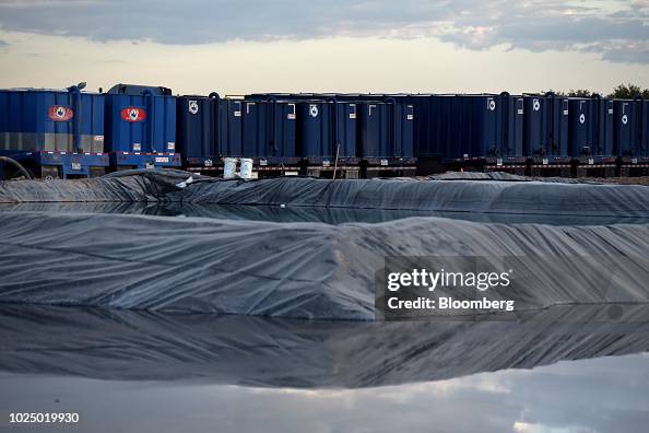 Colgate Container Storage containers stand near a frack pond at a Colgate Energy LLC ...