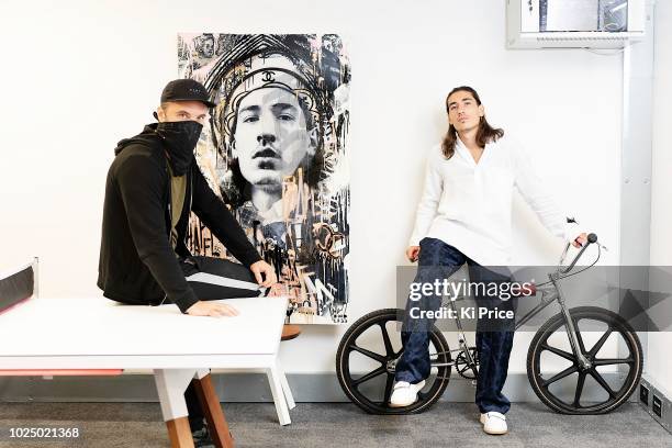 London artist, Endless presents Arsenal player Hector Bellerin with a painting of himself on August 28, 2018 in London, England.