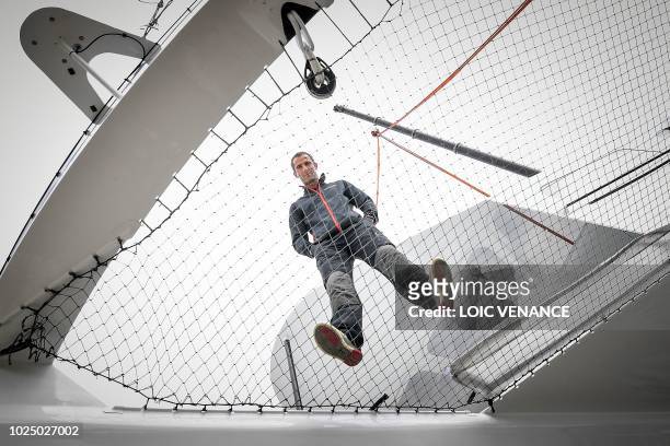 French skipper Armel Le Cleach poses onboard his Ultim multihull Banque Populaire as it is lifted to be launched on August 29, 2018 in Lorient,...