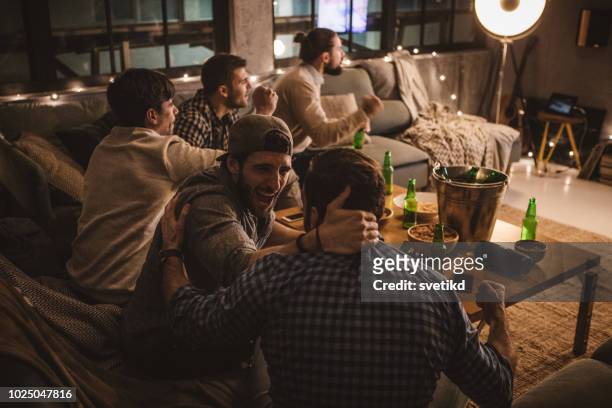 friends spend weekend together watching tv - sports round stock pictures, royalty-free photos & images