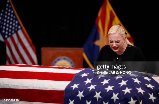 Meghan McCain, daughter of US Senator John McCain , grieves over the casket of her father during a memorial service at the Arizona Capitol on August...