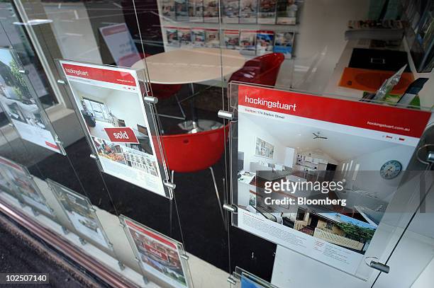 Properties are advertised for sale in the window of real estate agent Hocking Stuart, in Carlton, an inner suburb of Melbourne, Australia, on Monday,...