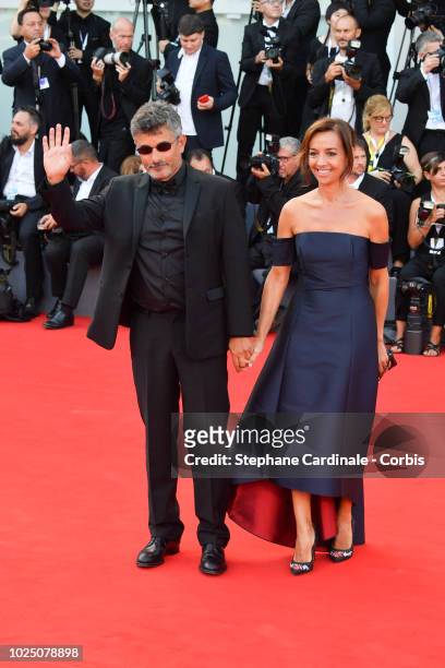 Official Competition jury member Paolo Genovese and Federica Rizzo walk the red carpet ahead of the opening ceremony and the 'First Man' screening...
