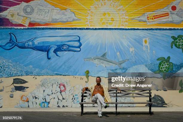 Man suns himself on the Coney Island boardwalk on a hot afternoon, August 29, 2018 in the Brooklyn borough of New York City. The New York City area...