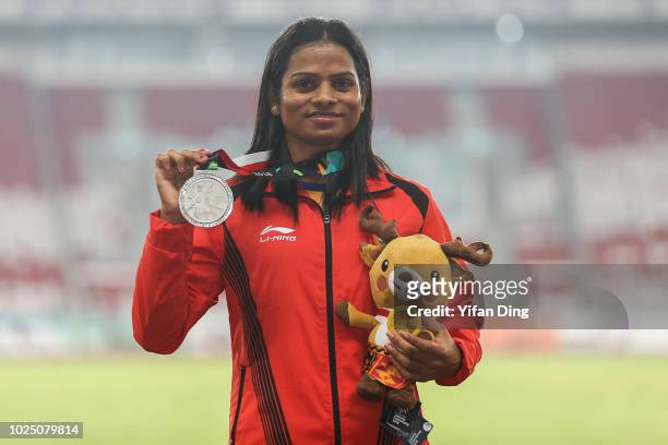 Silver medalist Dutee Chand of India poses for photo during Athletics WomenÕs 200m medal ceremony at GBK Main Stadium on day eleven of the Asian...