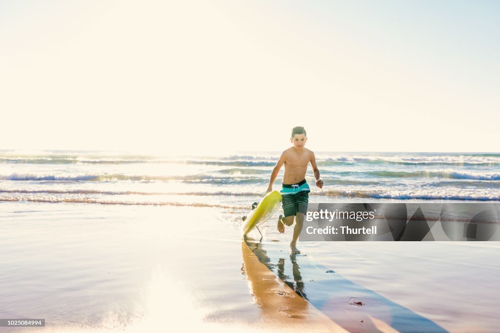 Australian Aboriginal Boy At Beach With Surf Rescue Board