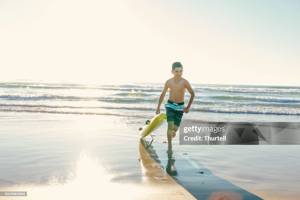 Australian Aboriginal Boy At Beach With Surf Rescue Board