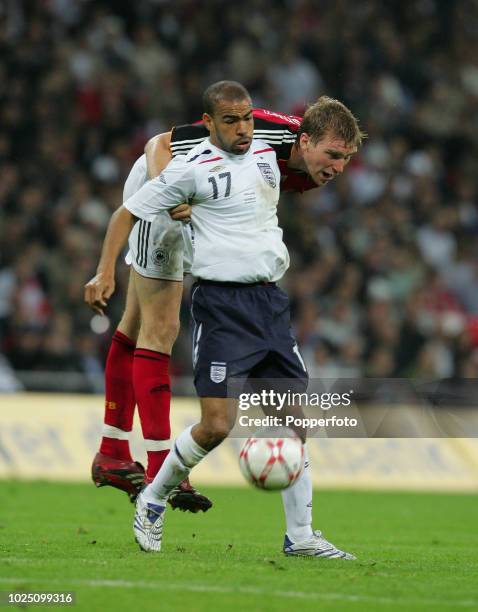 Per Mertesacker of Germany and Kieron Dyer of England in action during the international friendly match between England and Germany at Wembley...